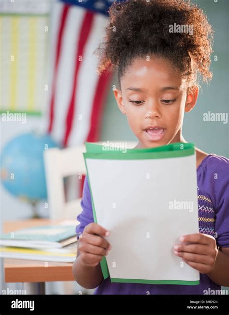 Mixed Race Girl Reading Report At School Stock Photo Alamy