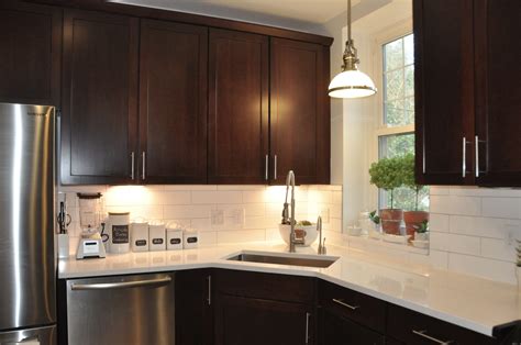 Kitchen islands & carts to reflect your style and inspire your home. white quartz counters and white extra long subway tile backsplash with dark cabinets and ...