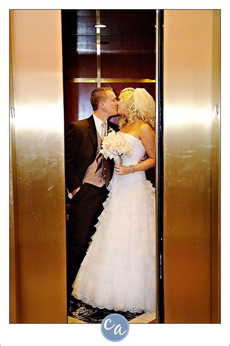 bride and groom kissing in the elevator blue winter wedding groom suit black wedding