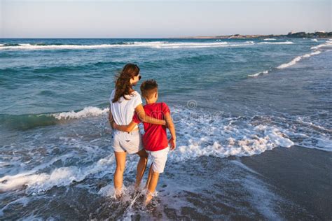 Mom And Son Walking And Playing On The Beach Stock Photo Image Of