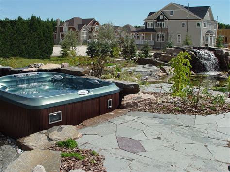Hot Tub Installed Partially In Ground With Lots Of Stonework And