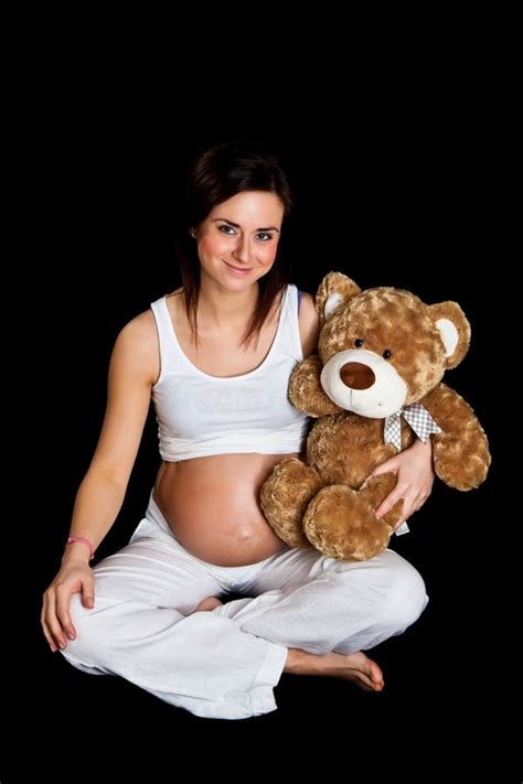 brunette pregnant woman with teddy bear on black stock image image of isolated expectant