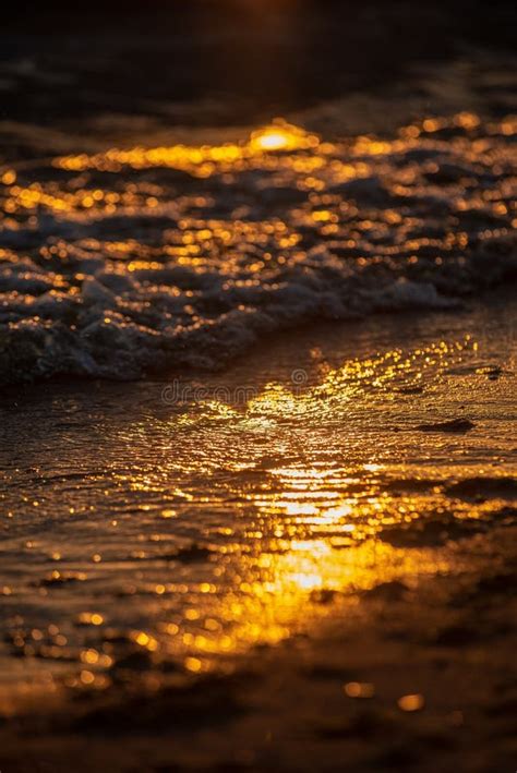 Colorful Sunset Over Calm Sea Beach With Dark Blue Water And Dramatic