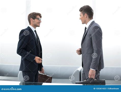 Two Business People Talking Standing In The Office Stock Image Image