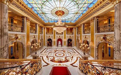 An Ornately Decorated Lobby With A Red Carpet And Chandelier Above The