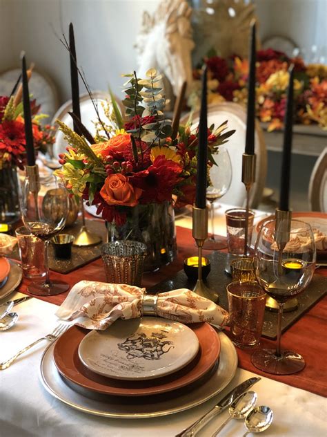 Candles are an easy way to add dimension and ambiance to your tablescape without breaking the bank. Fall table setting, black candles, orange, rust, silver ...