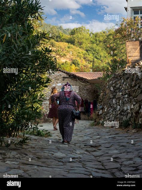 sirince village izmir turkey august 23 20121 back rear view of women walk on stone road in