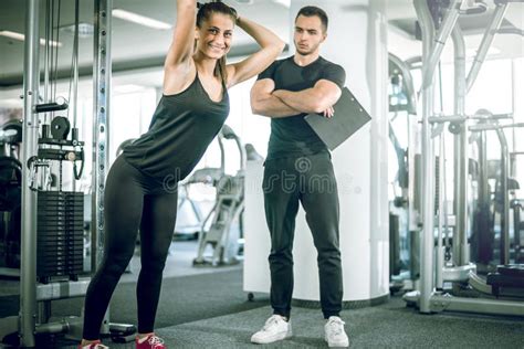 Personal Fitness Trainer With His Client In Gym Stock Photo Image Of