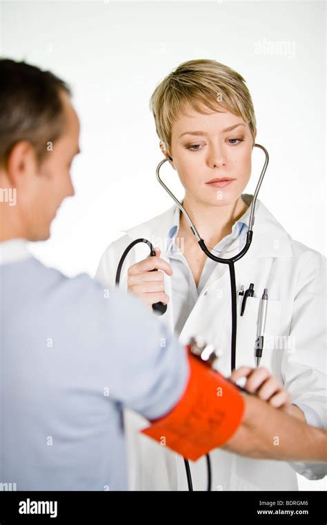 A Female Doctor Using A Blood Pressure Gauge Stock Photo Alamy
