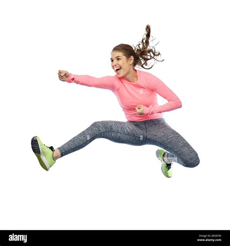 Happy Sporty Young Woman Jumping In Fighting Pose Stock Photo Alamy