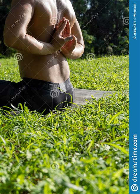Latin American Man Doing Yoga Posture On The Grasses Stock Image
