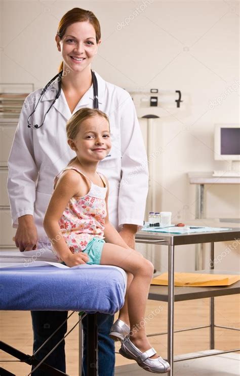 Doctor Giving Girl Checkup In Doctor Office Stock Photo Spaces