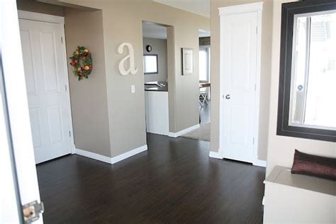 A stylish family home inspired by the hamptons. Dark wood floors, white trim and doors, wall color... It's ...