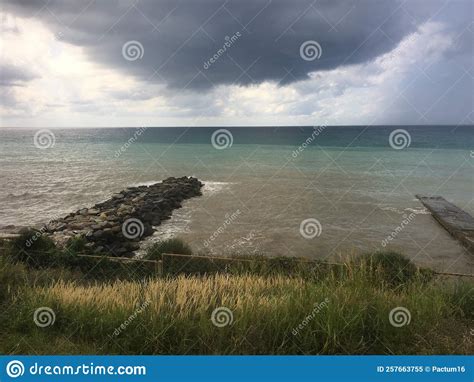 Scenic Seaside Landscape On Empty Black Seacoast With Stormy Waters