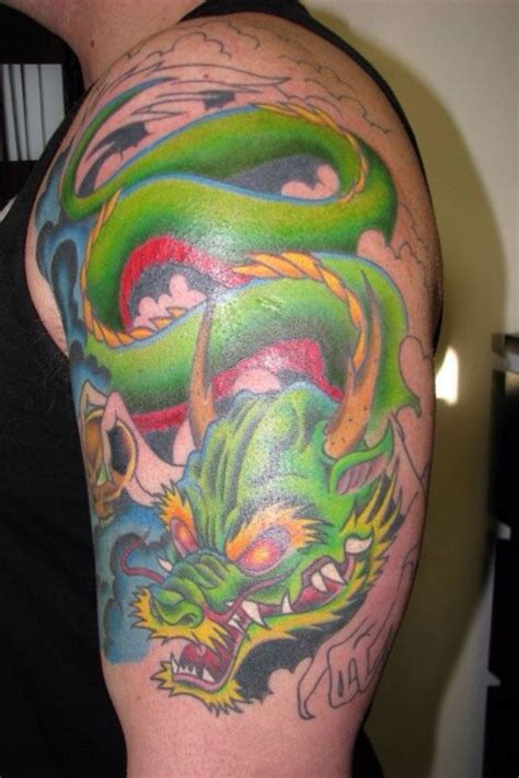 Black ink 3d dragon with cross tattoo on left back shoulder by marvin silva. http://inkchill.com/green-dragon-tattoo/ | Tattoos ...