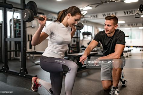 Fitness Instructor Guiding Young Woman When She Exercises Fitness