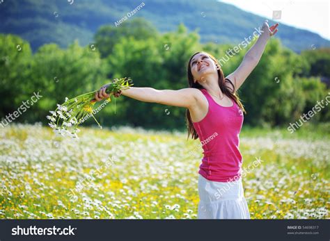 Young Beautiful Girl Resting In Flower Field Stock Photo 54698317