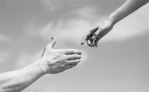 Premium Photo Giving A Helping Hand Hands Of Man And Woman On Blue