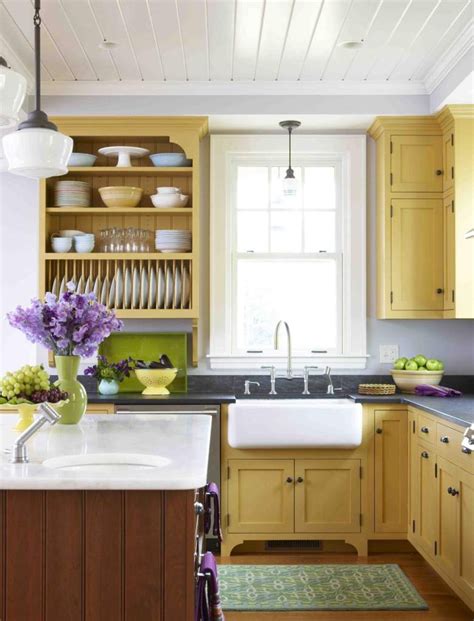 A Kitchen With Yellow Cabinets And Gray Walls Like Ours