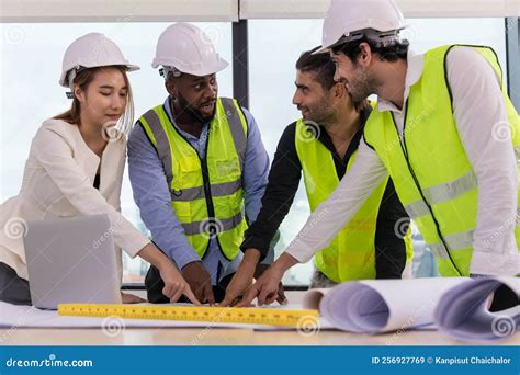 A Team Of Engineers Builders On The Background Of A Construction Site