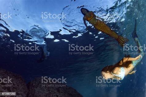 Mermaid Swimming Underwater In The Deep Blue Sea Stock Photo Download