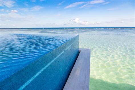 Beautiful Outdoor Infinity Swimming Pool In Hotel Resort With Sea Ocean