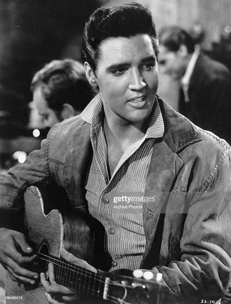 Elvis Presley Plays Guitar In A Scene From The Film Flaming Star