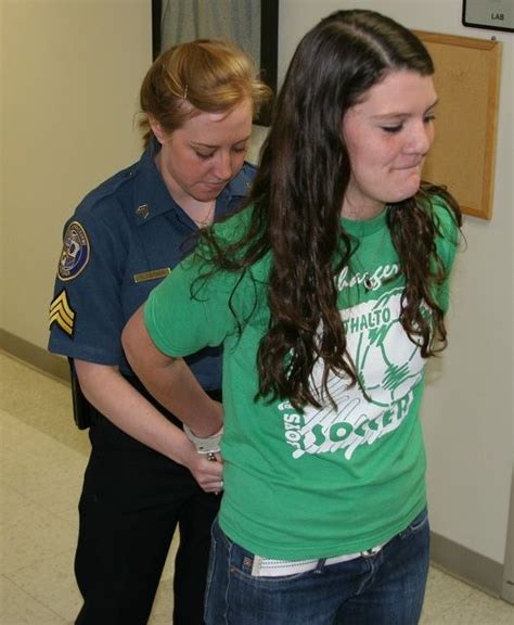 Young Woman Gets Her Hands Cuffed Behind Back At Police Open Day Police Women Women Female Cop