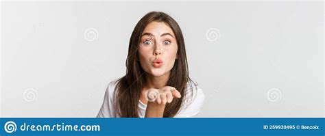 close up of beautiful flirty girl pouting lips and sending air kiss at camera stock image