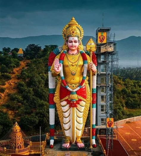 A Large Statue Of The God In Front Of A Building With Mountains And