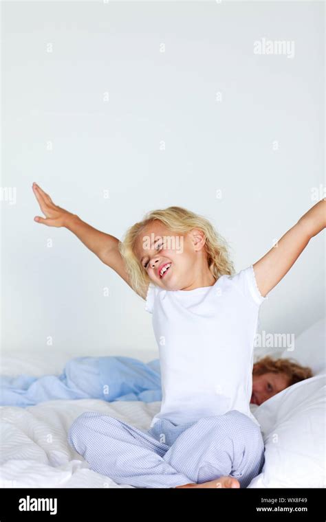 Little Girl Stretching Her Arms In Bed Stock Photo Alamy