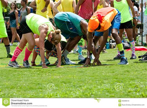 Because lets face it, the hundreds of ho. Young Adults Bend And Stretch Playing Grass Twister ...