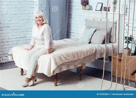 Cheerful Elderly Woman Sitting In The Bedroom Stock Image Image Of