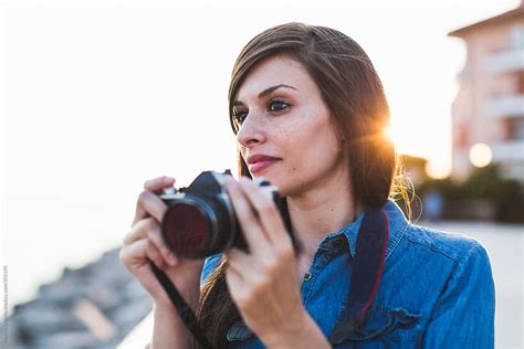 Woman Photographer Taking Pictures At Sunset By Stocksy Contributor