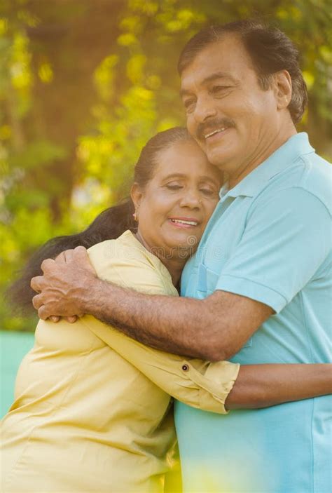 Vertical Shot Of Happy Indian Elderly Senior Woman Embracing Or Hugging