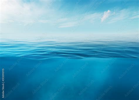 Blue Sea Or Ocean Water Surface And Underwater With Sunny And Cloudy