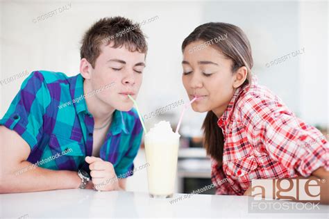 Teenage Couple Sharing Milkshake Stock Photo Picture And Royalty Free