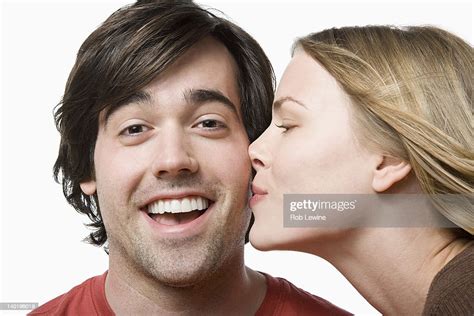 Studio Portrait Of Young Couple Kissing High Res Stock Photo Getty Images
