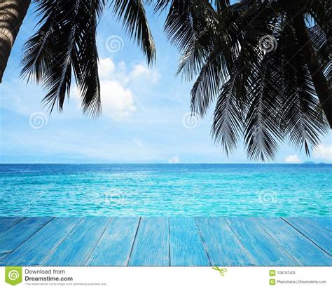 Blue Wood Over Turquoise Sea With Silhouette Palm Trees Stock Image