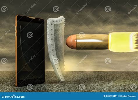 Close Up Of Smartphone Or Mobile Phone Protected By Shield From A Giant Bullet On Asphalt In