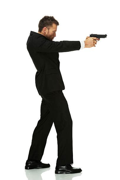 Man Pointing Gun Suit Full Body Pictures Images And Stock Photos Istock