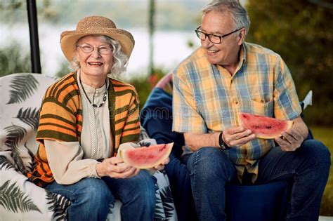 Senior Couple On Romantic Vacation Eating Watermelon Stock Image