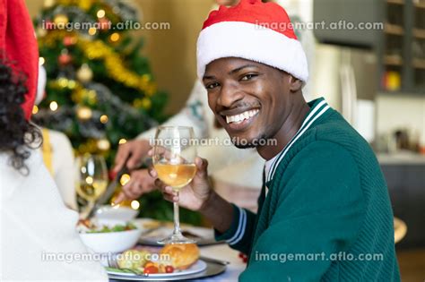 Happy African American Man In Santa Hat Toasting Celebrating Christmas