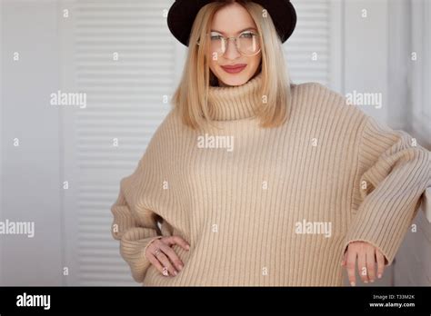 Stylish And Beautiful Young Blonde In Black Felt Hat And Beige Oversize Sweater Young Woman