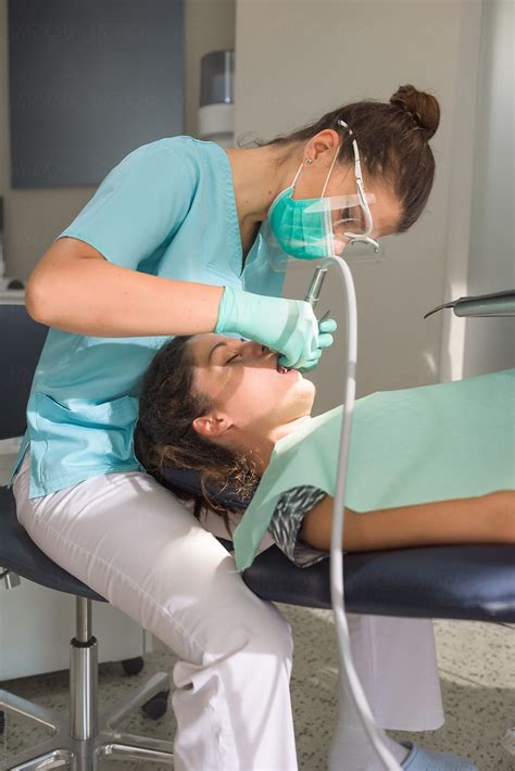 Orthodontist Curing Her Patient Using Dental Drill By Stocksy Contributor Ibexmedia Stocksy