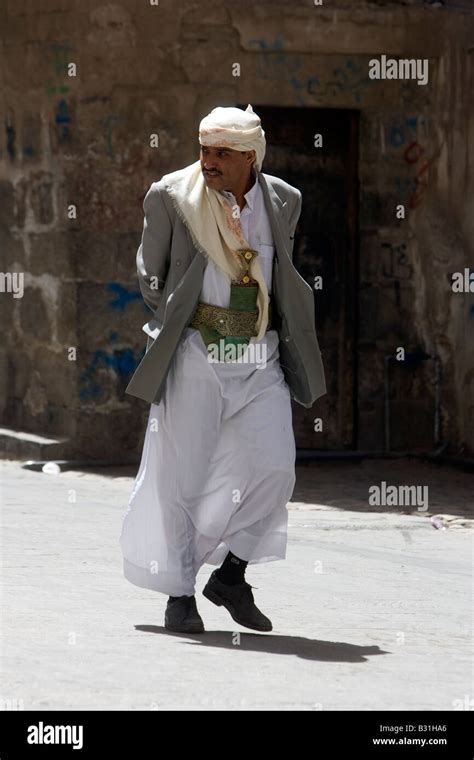 A Old Muslim Man From Yemen Walking Through Old Sanaa City Wearing His