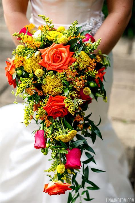Maybe you would like to learn more about one of these? A cascading bridal bouquet of orange, pink and red roses ...