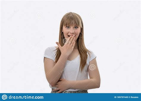 Young Girl Covers Her Hand Over Her Mouth Wondering At Something Or