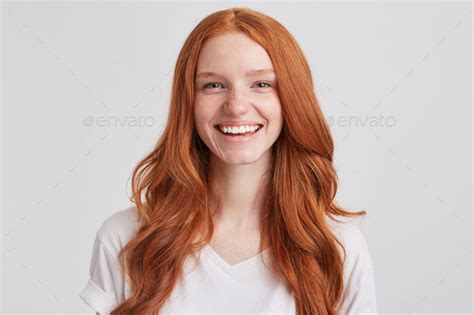 Portrait Of Cheerful Pretty Redhead Young Woman With Long Wavy Hair