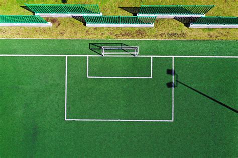 Zooming Out At The Goal Of A Football Field With Bright Green